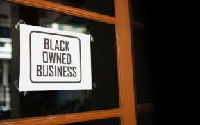A sign in a door saying black-owned business