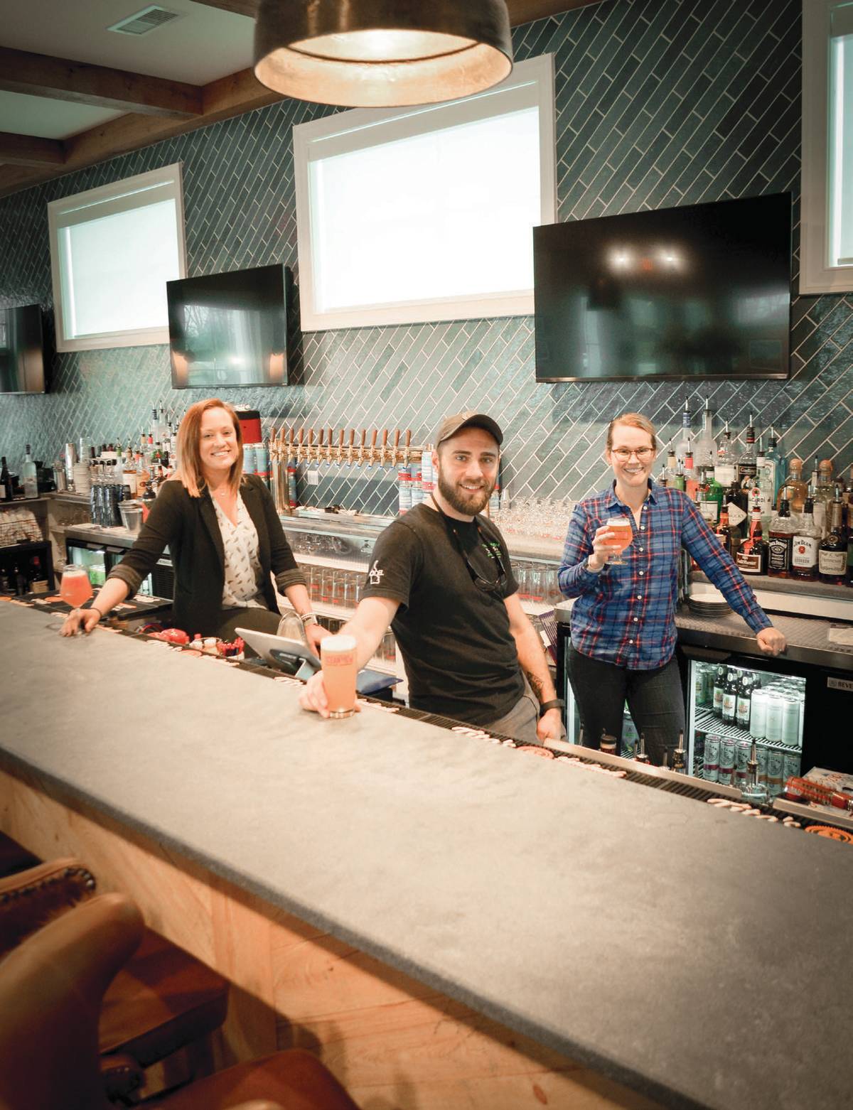 Ocean View brewing's general manager, head brewer, and beer director all behind the bar
